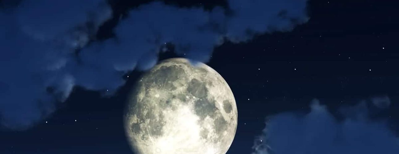 A bright full moon shines in a dark night sky, surrounded by scattered clouds and faint stars.